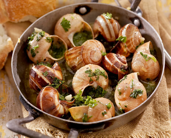 Escargot-cooked-in-a-small-saucepan-in-a-herb-butter-sauce.jpg